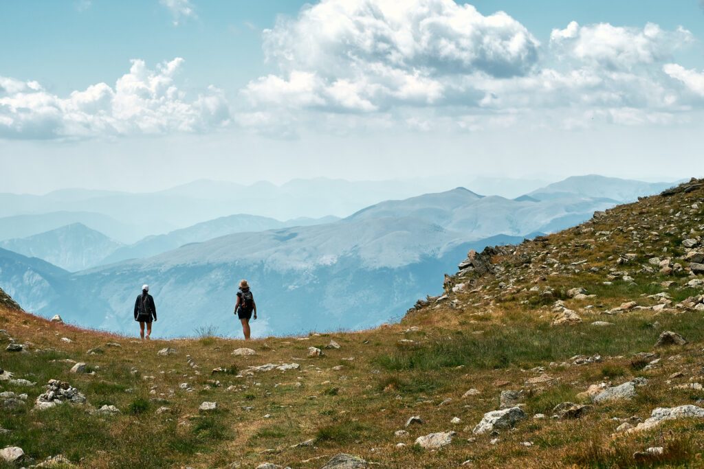 BEST GROUP TOURS IN INDIA : TOP DESTINATION FOR UNFORGATABLE JOURNEY back view photo of hikers standing at the edge of a hill in the french riviera backcountry